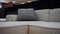 The filmed frame approaches a gray pillow, on a comfortable white sofa. 4k video.