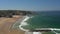 Filming the beautiful bay in the Portuguese town of Odeceixe in the summer with tourists on the beach. Portugal Alentejo