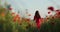 Filming from below of incredible brunette woman running and having fun through a poppy field. Charming lady in a red