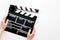 Filmmaker accessories. Clapperboard on white background top view copyspace