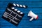 Filmmaker concept. Electronic megaphone and clapperbord on blue wooden background top view