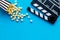 Filmmaker profession with clapperboard and popcorn on blue background top view copyspace