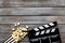 Filmmaker profession with clapperboard and popcorn on wooden background top view copyspace