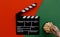 Filmmaking concept. Movie Clapperboard. Cinema begins with movie clappers. Movie clapper board on green and on red background and