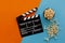 Filmmaking concept. Movie Clapperboard. Cinema begins with movie clappers. Movie clapper on an orange and a blue background and