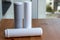 Filter cartridges for drinking water purification for on a wooden table against a blurred background. Water filtration RO