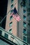 Filtered image waving American flag on federal buildings in downtown Chicago