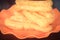 Filtered image youtiao or Asian doughnut in orange plate on wooden table close-up