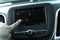 Filtered tone male hand changing the radio station on car LCD infotainment screen