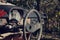 Filtered vintage photo of steering wheel and rusty speedometer on dashboard