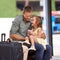 Finally some dad time. A father and daughter having fun together while waiting for their bus.