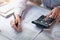 finance and accounting concept. business woman working on desk using calculator to calculate