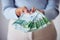 Finance, bonus and investment hand holding money, cash or bank notes for savings, wealth or spending closeup. Woman with