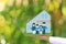 Finance,Businesswoman holding model house and model family on natural green background, New home and Real estate concepts