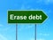 Finance concept: Erase Debt on road sign background