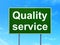 Finance concept: Quality Service on road sign background