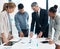 Finance, data and business people working on a graph in a modern office. Documents, teamwork and a multiracial group