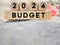 Finance and Economy Concept. 2024 budget text on wooden blocks background.