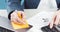 Finance. Hand with calculator on financial graphs on desk