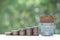 Finance, Model house and Stack of coins money on natural green background, Business investment and real estate