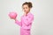 Finance. portrait of a girl in a pink suit holding a money jar on a white background with copy space