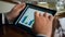 Finance professional using tablet. Closeup man hands touch pad screen graphics