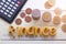 Finance word on wood table ,pile coin money with calculator, concept in grow and walk step by step for success