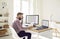 Financial accountant reading a document while doing paperwork at his office desk