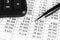 Financial concept. Calculator, pen and glasses on financial documents. Financial accounting. Balance sheets. Closeup of financialF