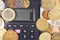 Financial concept. Calculator surrounded by various world currency coins closeup