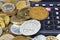 Financial concept. Calculator surrounded by various world currency coins closeup