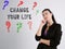 Financial concept about CHANGE YOUR LIFE question marks with inscription on the gray wall