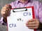 Financial concept meaning Certified Public Accountant CPA vs. CFA Chartered Financial Analyst with inscription on the sheet