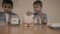Financial education and child savings. Two boys kids sorting coins between toys jar and emergency fund with piggy bank