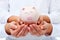 Financial education concept - adult and child hands holding piggy bank