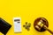 Financial failure, bankruptcy concept. Judge gavel, wallet, coins, calculator on yellow background top view copy space