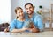 Financial planning happy family couple with piggy Bank at home