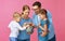 Financial planning happy family mother father and children with piggy Bank on pink