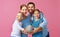 Financial planning happy family mother father and children with piggy Bank on pink