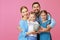 Financial planning happy family mother father and children with piggy Bank on pink