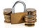 Financial security concept with stacks of coins and padlock on white background