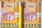 Financial settlements in india, concept, 200 rupee banknotes stacked nicely side by side, yellow pen in between, close-up, top