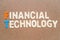 Financial Technology wording on brown background