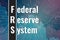 Financial term FRS - Federal Reserve System on blue and magenta finance background from graphs, charts. Trend Up and Down. 3D