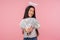 Financial wealth. Portrait of happy smiling girl with halo over head holding out money to camera