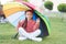 Find peaceful private space to relax. Under big umbrella. Girl child long hair meditate park under umbrella. Stay