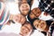 They always find a reason to smile. Low angle portrait of a group of diverse schoolchildren standing in a huddle.