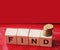 Find word Word Written In Wooden Cubes and coins. Business concept