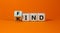 Find your kind symbol. Turned cubes with words find kind. Beautiful orange table, orange background, copy space. Business,