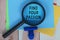 Find Your Passion on Blue Adhesive Note With Magnifying Glass On Wooden Desk.